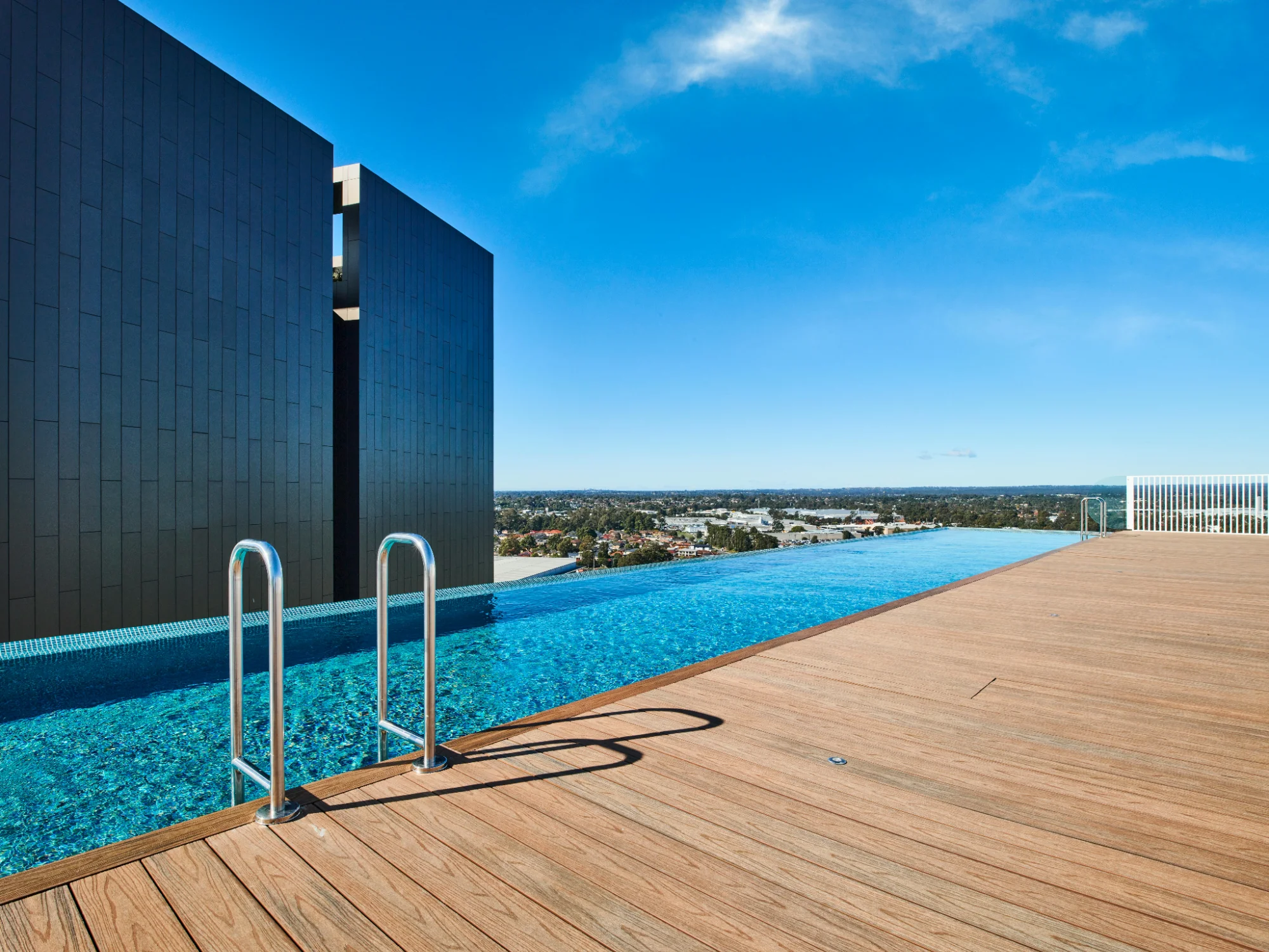 Commercial rooftop infinity pool overlooking city skyline